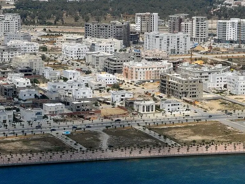 Aerial view of a North African coastal city with low rise housing
