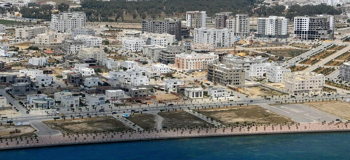 Aerial view of a coastal North African town with new residential construction